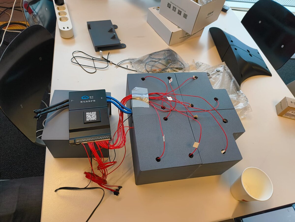 Custom lithium battery pack fully wired, with a BMS protection board and hand-soldered balance wires.