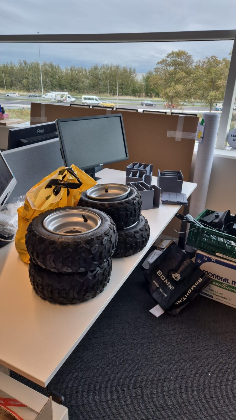 Set of four all-terrain wheels and tires prepared for assembly.